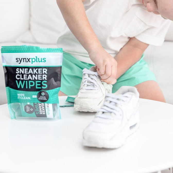 boy cleaning sneakers with synxplus sneaker cleaner wipes, microdots wipes, clean sneakers, keep kicks clean, shoes, sneakers