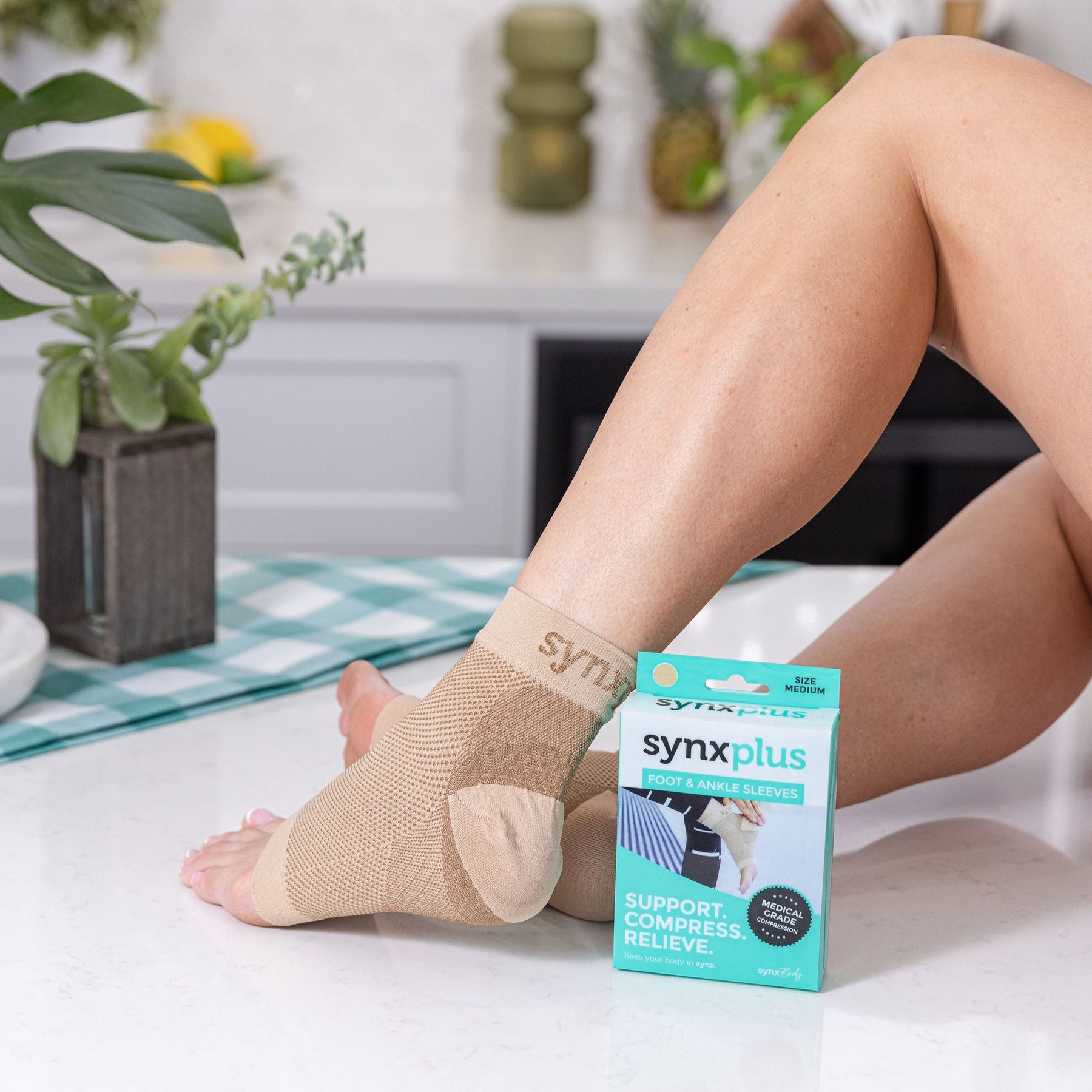 lady wearing synxplus foot and ankle compression sleeves, heel pain