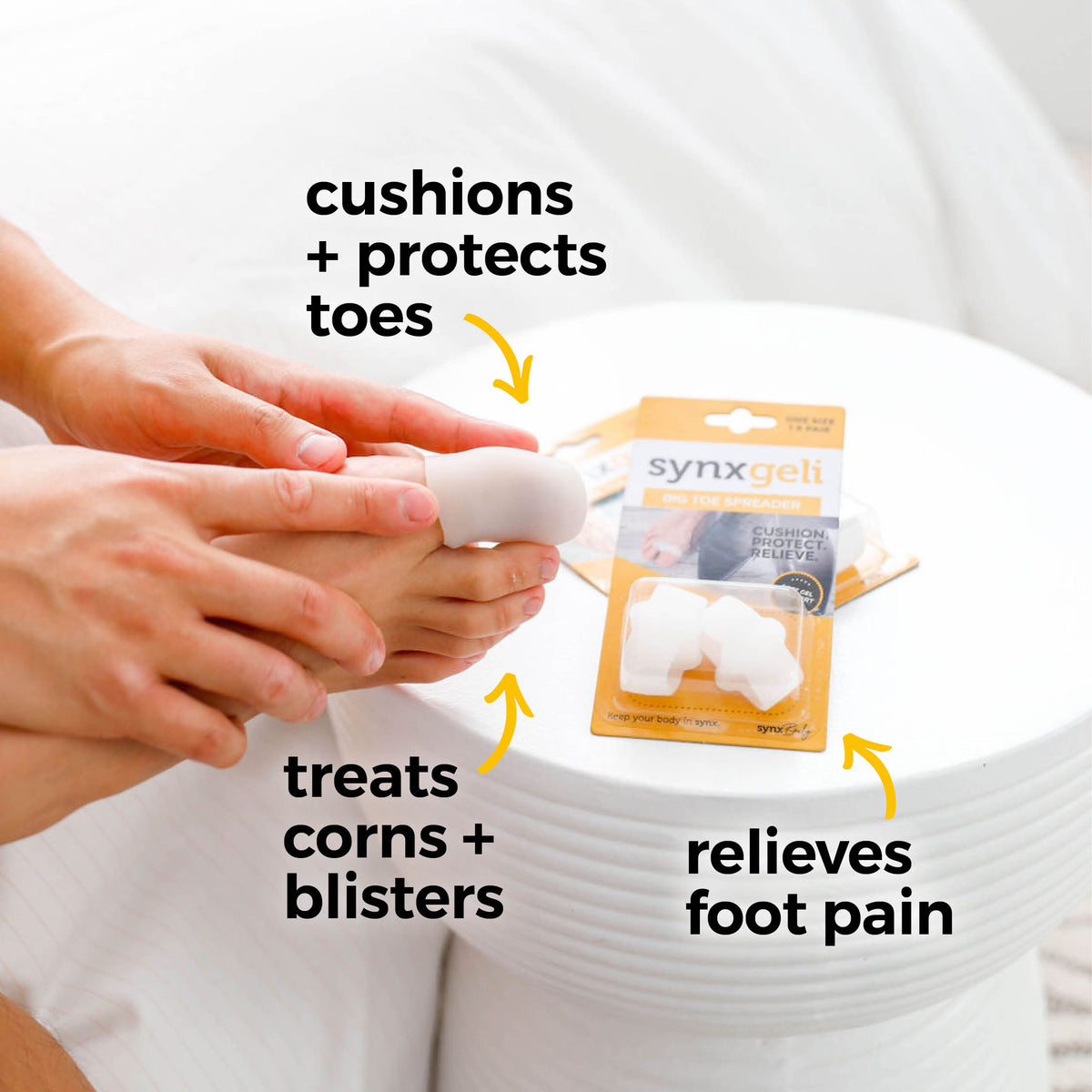 a man holding is foot with big toe wearing synxgeli large toe sleeve, ideal for treating, reducing or preventing corns, blisters and toe deformities