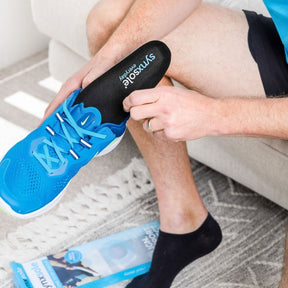 man inserting into sneaker synxsole one stop insoles, align the body, support feet, support lower limbs, protect joints