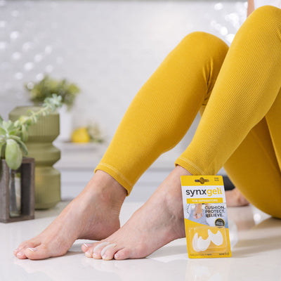 side view of lady wearing synxgeli toe separators to treat corns between the toes or pain caused by overriding or crowding toes