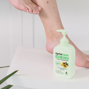 video lady applying synxeaze heel relief balm pump with papaya and AHAs to moisturise dry and cracked heels