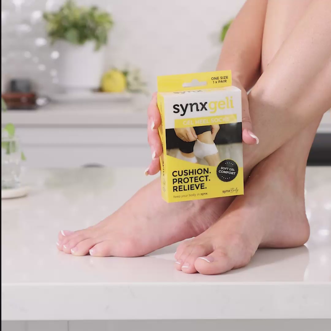 video of lady wearing synxgeli heel socks which are a barrier for bony deformities at the back of the heel and relieve dry cracked heels